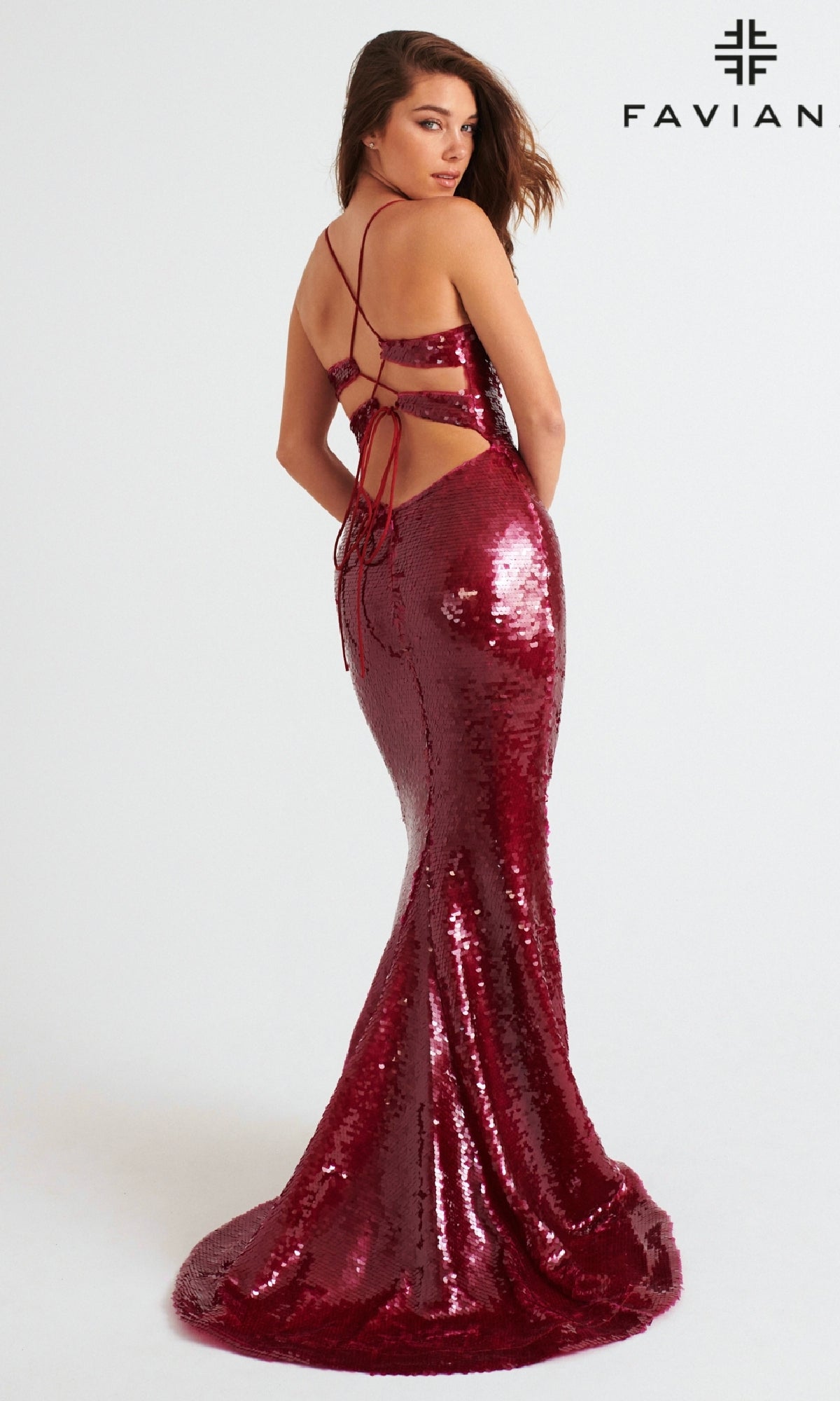 A woman models the Faviana 11261 long prom dress in burgundy sequins, featuring a strappy open back and floor-length mermaid silhouette, against a plain white background.